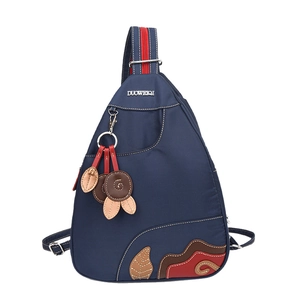 Waterproof dark blue nylon sling bag with red zipper and colorful embroidery detail