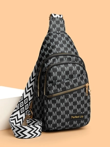 Detail of crossbody chest bag featuring monogram pattern and geometric woven strap