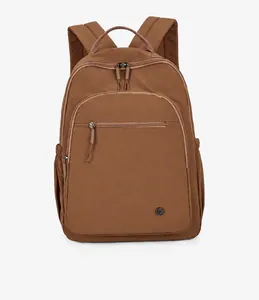Detailed front view of brown lightweight outdoor backpack with circular metal logo