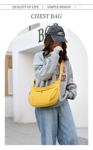Detail shot of bright yellow Oxford fabric crescent bag with wide shoulder strap