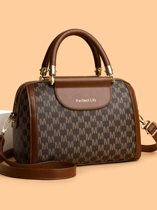Detailed side view of the Boston handbag with monogram print and golden metal logo