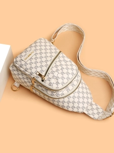 Close-up of beige crossbody bag with M-letter print and adjustable woven strap