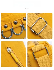 Detail view of premium stitching and silver metal hardware on yellow crossbody bag
