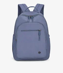 Detail of blue outdoor backpack with smooth nylon texture and front zipper pocket
