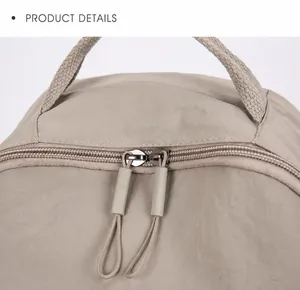 Close-up of a durable khaki nylon backpack with heavy-duty dual zippers and reinforced handle