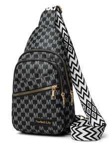 Close-up of lightweight crossbody bag with letter M patterns and gold metal zippers