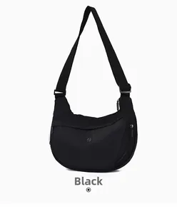 Detail view of crescent oxford cloth crossbody bag with adjustable wide fabric shoulder strap
