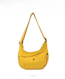 Front view of yellow oxford fabric crescent crossbody bag with adjustable strap and zip detail