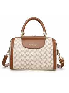 Detail of Boston handbag featuring beige monogram pattern and brown leather flap with gold hardware