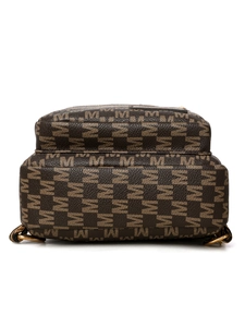Detail of dark brown leather texture with repeat M pattern and golden metal rings