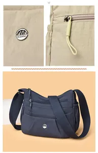 Detail of multi-pocket nylon crossbody bag with metal logo and durable zipper pulls
