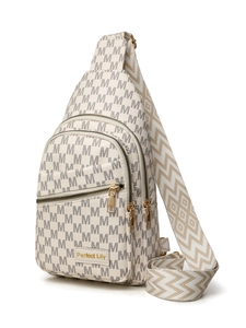 Detail view of cream crossbody bag featuring M-pattern monogram and woven wide strap