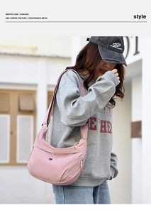 Pink nylon crossbody bag detail with large capacity, front zip pocket, and wide strap