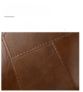 Detailed macro view of premium brown leather texture with durable reinforced stitching
