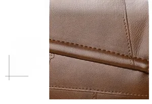 Macro shot of precise stitching and premium texture on dark brown leather shoulder bag
