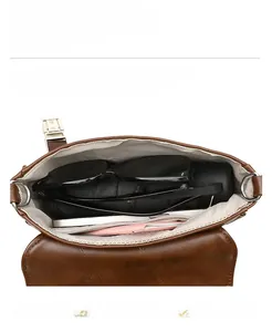 Internal view of the brown leather shoulder bag showing compartments and daily essentials