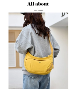 Close-up of bright yellow nylon crescent crossbody bag with adjustable wide strap