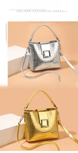 Detail of silver and gold bucket bags showing embossed crocodile texture and metal clasp