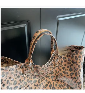 Close-up of leopard print tote bag straps with durable stitching and waterproof finish