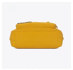 Detailed bottom view of yellow crossbody bag showing wide base and reinforced stitching