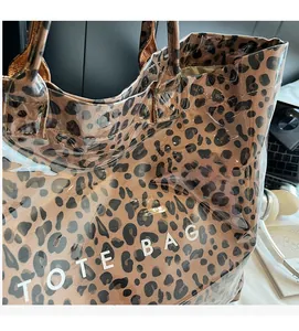 Detail of leopard print inner fabric visible through transparent PVC on the tote bag