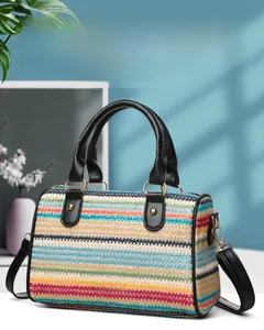 Macro detail of colorful woven straw pattern and leather handle on a beach tote bag