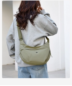 Detail view of olive green oxford crescent crossbody bag with adjustable wide shoulder strap