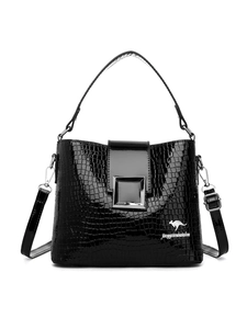 Detail shot of the glossy black crocodile-textured bucket bag with silver metal buckle