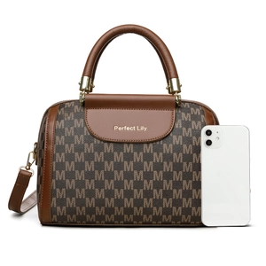Brown Boston bag with M-letter print, top handles, and adjustable strap on white background
