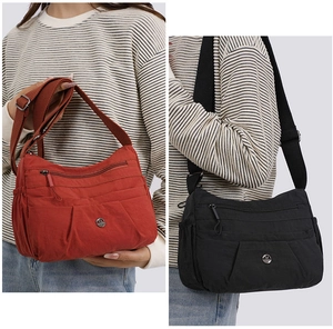 Detail showing burgundy and black nylon cross-body bags with multiple zipper pockets