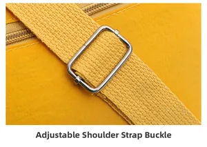 Detail of adjustable metal buckle and woven strap on a vibrant yellow crossbody bag