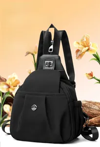 Detailed view of black nylon multi-functional chest bag with silver metal M logo
