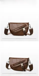 Detail view of brown vintage saddle bag with textured stitching and metal buckle