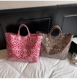 Macro view of glossy leopard print tote bags with waterproof finish and TOTE BAG print
