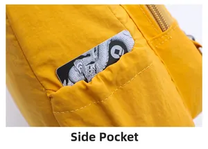 Detail showing the side elastic pocket and metal zipper of the yellow nylon crossbody bag