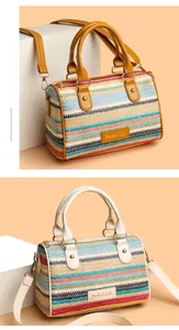 Detail view of woven Boston bags with multi-colored stripes and leather handles