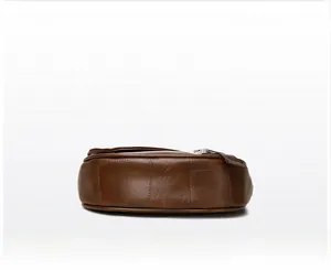 Detailed base view of dark brown leather handbag showing stitching and textured material