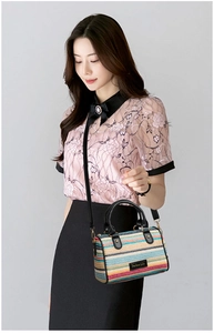 Detail of colorful striped woven bucket bag featuring Perfect Lily brand logo and strap