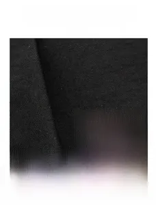 Detail showing the wear-resistant black woven fabric and metal logo plate on the backpack