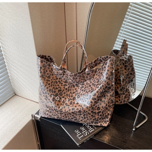 Detail of large leopard print tote bag with white TOTE BAG text in a modern interior