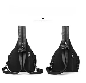 Detail of black versatile backpack showing multiple adjustable straps and silver zippers