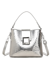 Close-up of silver bucket bag featuring crocodile texture and metallic buckle detail