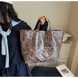 Close-up of leopard print tote bag with transparent waterproof coating and white text