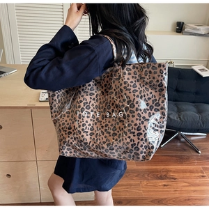 Close-up of leopard print canvas tote bag with transparent PVC waterproof outer layer