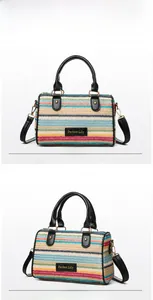 Detail view showing multi-color woven texture and leather handles of the beach bag