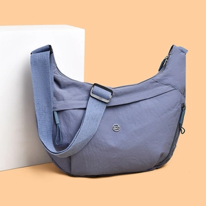 Minimalist grey-blue nylon crescent crossbody bag with adjustable wide fabric strap