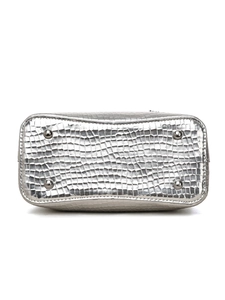 Detail view of silver embossed leather bag bottom with protective metal studs