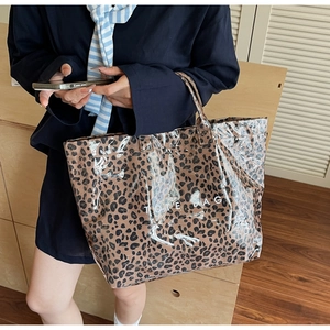 Detail of leopard print tote bag with waterproof PVC overlay and TOTE BAG lettering