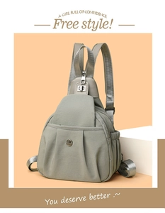 Detail of gray-green waterproof nylon bag featuring pleated design and silver buckle