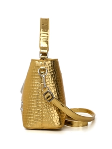 Detail of metallic golden bucket bag with crocodile pattern and silver hardware buckle